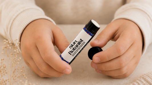 child holding open non-toxic Skin Botanist kids lip balm tube 