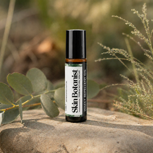Skin Botanist Botanical Insect Repellent Oil amber glass roll-on bottle outdoors near plants
